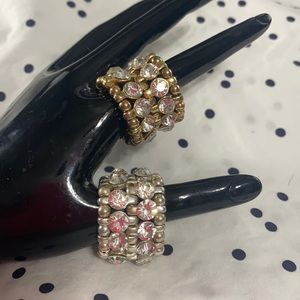 PRE OWNED!!! 2 metal rings with crystals. One gold/ One silver
